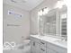 Modern bathroom features double sinks, white cabinets, and stylish lighting, plus a glass shower at 4248 Stone Lake Dr, Zionsville, IN 46077