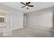 Spacious primary bedroom featuring carpeted floors, fan and access to ensuite bathroom at 4248 Stone Lake Dr, Zionsville, IN 46077