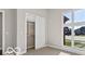 Bright bedroom with a large window showcasing the exterior view, plus a closet with a sliding door at 4248 Stone Lake Dr, Zionsville, IN 46077