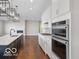 Modern kitchen featuring a central island with quartz countertops, stainless appliances, and pendant lighting at 4248 Stone Lake Dr, Zionsville, IN 46077