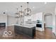 Modern kitchen featuring a central island with quartz countertops, stainless appliances, and pendant lighting at 4248 Stone Lake Dr, Zionsville, IN 46077