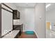 Hallway with built in storage and access to garage with a 'Waterfront' welcome mat at 4248 Stone Lake Dr, Zionsville, IN 46077