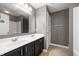 Bathroom with double sink vanity, gray walls, and neutral flooring at 4431 Hickory Stick Row, Greenwood, IN 46143