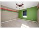 Bedroom with unique color scheme, carpeting, and a modern ceiling fan at 4431 Hickory Stick Row, Greenwood, IN 46143