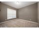 Neutral bedroom features soft carpet and a window for natural light at 4431 Hickory Stick Row, Greenwood, IN 46143