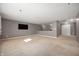 Spacious bonus room with neutral carpet, a wall-mounted television and double doors to the hallway at 4431 Hickory Stick Row, Greenwood, IN 46143