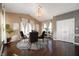 Dining room features hardwood floors, a stylish chandelier and a round dining table with seating for four at 4431 Hickory Stick Row, Greenwood, IN 46143