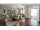 Open-concept dining room featuring hardwood floors, stylish furniture, and decorative wallpaper at 4431 Hickory Stick Row, Greenwood, IN 46143
