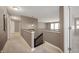 Upstairs hallway features neutral carpeting, spindled stairwell, and access to the upper level at 4431 Hickory Stick Row, Greenwood, IN 46143