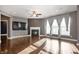 Spacious living room with hardwood floors, fireplace, and large windows for natural light at 4431 Hickory Stick Row, Greenwood, IN 46143