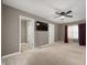 Spacious main bedroom features an ensuite bath, TV, and a ceiling fan at 4431 Hickory Stick Row, Greenwood, IN 46143