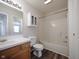 Bathroom with wood vanity, shower and tub combo, and storage at 475 Glenn Villa Ln # 144, Avon, IN 46123