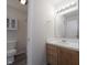 Bright bathroom featuring a wooden vanity, white cabinets, and a well-lit mirror at 475 Glenn Villa Ln # 144, Avon, IN 46123