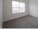 Well-lit bedroom with window and carpeted flooring at 475 Glenn Villa Ln # 144, Avon, IN 46123