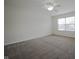 Bright, carpeted bedroom with a ceiling fan and large window providing natural light and a comfortable ambiance at 475 Glenn Villa Ln # 144, Avon, IN 46123
