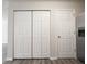 Hallway featuring a set of double doors and a regular door, next to a stainless steel refrigerator at 475 Glenn Villa Ln # 144, Avon, IN 46123