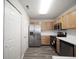 Modern kitchen featuring stainless steel appliances and light wood cabinetry, paired with wood floors at 475 Glenn Villa Ln # 144, Avon, IN 46123