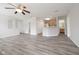 Open-concept living room with wood floors, a ceiling fan, and views of the kitchen and breakfast nook at 475 Glenn Villa Ln # 144, Avon, IN 46123