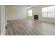 Spacious living room with wood floors, fireplace, ceiling fan, and natural light at 475 Glenn Villa Ln # 144, Avon, IN 46123