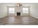 A well lit and spacious living area with hardwood floors, a classic fireplace, and large windows showcasing natural light at 475 Glenn Villa Ln # 144, Avon, IN 46123