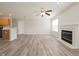 Bright and airy living room with wood flooring, fireplace, and ceiling fan at 475 Glenn Villa Ln # 144, Avon, IN 46123