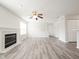Spacious living room with a fireplace, wood floors, large windows and a ceiling fan creating a comfortable atmosphere at 475 Glenn Villa Ln # 144, Avon, IN 46123