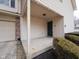 Covered porch with support columns leading to a dark front door and a two car garage on the left at 475 Glenn Villa Ln # 144, Avon, IN 46123