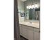 The bathroom features a vanity with a sink, mirror, neutral paint, and modern art at 530 Lansdowne Rd, Indianapolis, IN 46234
