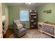 This Bedroom is cute with an adorable chair and crib at 530 Lansdowne Rd, Indianapolis, IN 46234