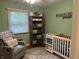 This Bedroom is cute with an adorable chair and crib at 530 Lansdowne Rd, Indianapolis, IN 46234
