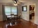 Inviting dining room with hardwood floors, a round table, and a view into the kitchen at 530 Lansdowne Rd, Indianapolis, IN 46234