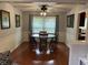 Bright dining room featuring hardwood floors, a ceiling fan, and classic wood furniture at 530 Lansdowne Rd, Indianapolis, IN 46234