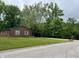 Beautifully maintained brick ranch home featuring a spacious front yard and mature trees at 530 Lansdowne Rd, Indianapolis, IN 46234