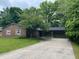 Charming brick ranch with an attached two-car garage and mature landscaping at 530 Lansdowne Rd, Indianapolis, IN 46234