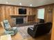 Cozy living room with wood paneling, a fireplace, and comfortable seating at 530 Lansdowne Rd, Indianapolis, IN 46234
