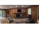Cozy living room featuring wood paneling, fireplace, and built-in shelving at 530 Lansdowne Rd, Indianapolis, IN 46234