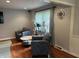 Cozy living room area with hardwood floors, decorative chairs, and a stylish side table at 530 Lansdowne Rd, Indianapolis, IN 46234