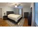 The main bedroom features a dark bed and dresser with a decorative rug at 530 Lansdowne Rd, Indianapolis, IN 46234