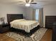 The main bedroom features a dark bed and dresser with a decorative rug at 530 Lansdowne Rd, Indianapolis, IN 46234