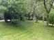 Lush, green backyard with mature trees offering ample shade and privacy at 530 Lansdowne Rd, Indianapolis, IN 46234