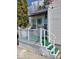 Charming front porch with a white railing, green turf, and decor at 5317 E 20Th Pl, Indianapolis, IN 46218
