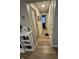 Hallway with modern lighting, neutral paint, and hardwood flooring connecting the home's rooms at 5317 E 20Th Pl, Indianapolis, IN 46218