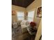 Cozy sitting area with a loveseat, flowers, two windows, and stylish decor at 5317 E 20Th Pl, Indianapolis, IN 46218