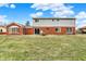 Spacious backyard featuring a brick patio, a large lawn, and mature trees at 5549 Hollister Dr, Indianapolis, IN 46224