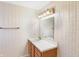 Bathroom featuring a sink, cabinet, light fixture, mirror, and floral wallpaper at 5549 Hollister Dr, Indianapolis, IN 46224
