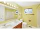 Bright bathroom featuring a double sink vanity, a large mirror, and a tub-shower combo at 5549 Hollister Dr, Indianapolis, IN 46224