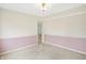 Bedroom with window, neutral walls, neutral carpet, and updated baseboards at 5549 Hollister Dr, Indianapolis, IN 46224