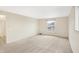 A bedroom has neutral-colored carpet, and a window looks out at the yard at 5549 Hollister Dr, Indianapolis, IN 46224