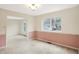 Dining room with updated baseboards, light fixture, and large window overlooking the backyard at 5549 Hollister Dr, Indianapolis, IN 46224