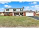 Inviting two-story home featuring a brick chimney, attached two-car garage, and manicured lawn at 5549 Hollister Dr, Indianapolis, IN 46224